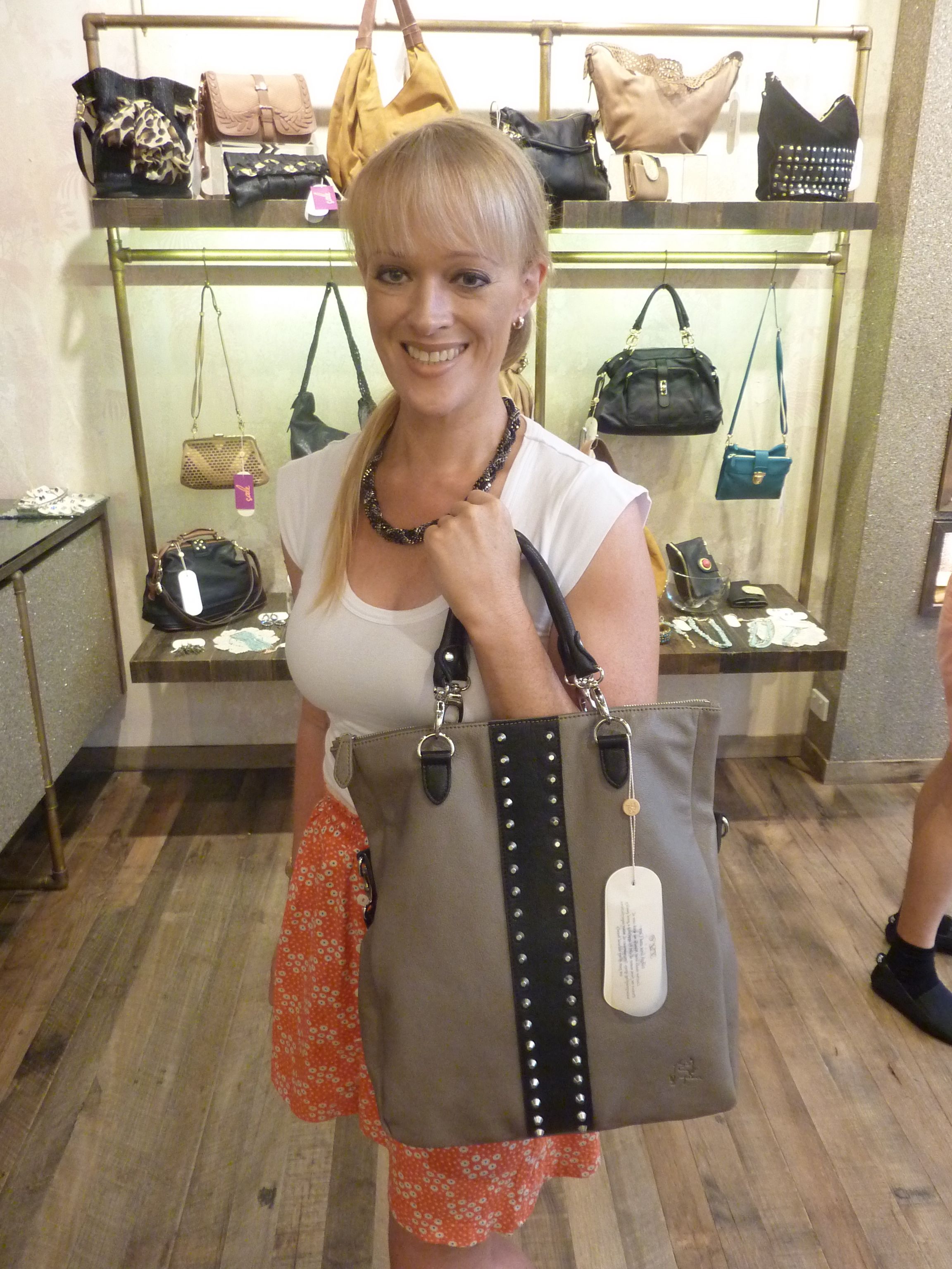 Rochelle wearing Ripple Effect necklace, $79 with Black Theodora studded tote, $279